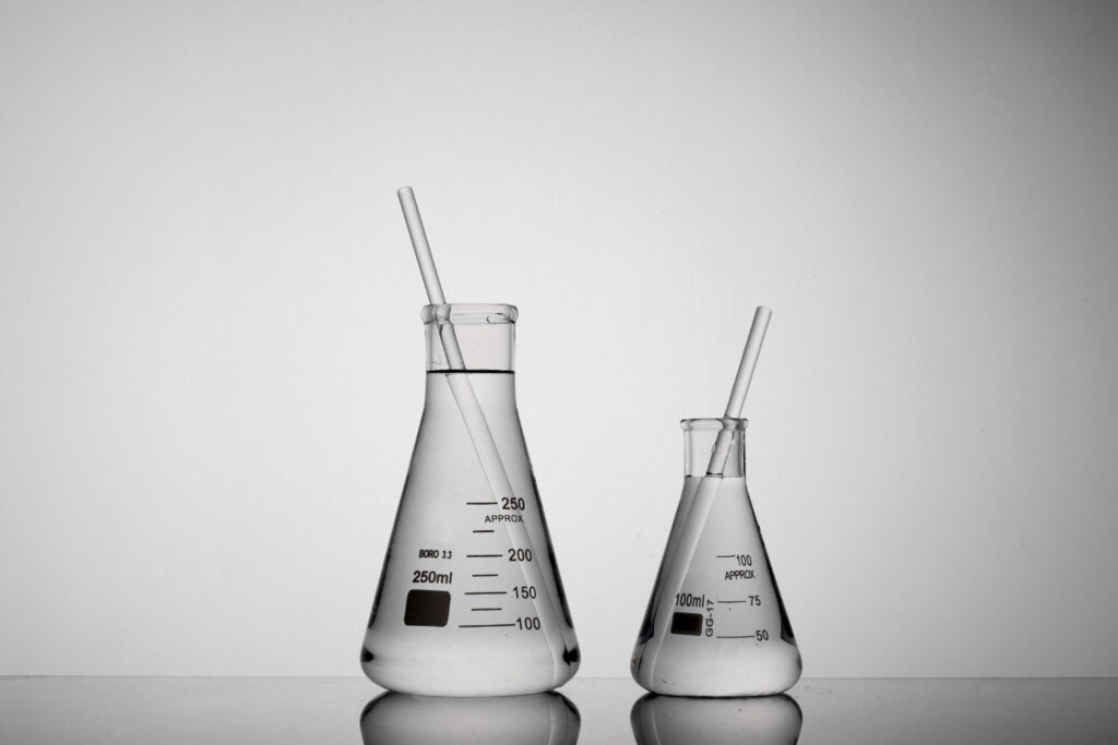 closeup shot of tubes inside erlenmeyer beakers